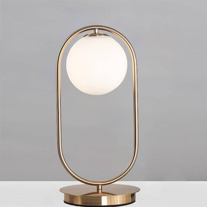 Lampe de chevet design en métal doré et boule en verre