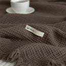 plaid coton uni a pompons doux salon
