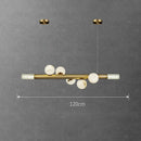 barre avec boule suspension table ronde en marbre éclairage salon de thé