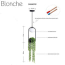 Suspension design LED avec boule en verre et fleurs suspendues