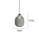 Suspension design LED avec sphère en verre et cercle cuivré