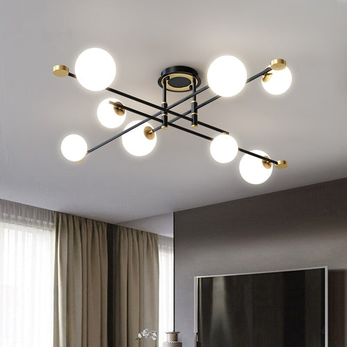 Lustre moderne LED bras croisés noirs et détails dorés Poline