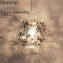 Lampe à poser boule en verre avec feuilles