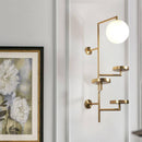 Applique murale design LED avec plusieurs disques dorés et boule en verre