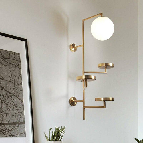 Applique murale design LED avec plusieurs disques dorés et boule en verre